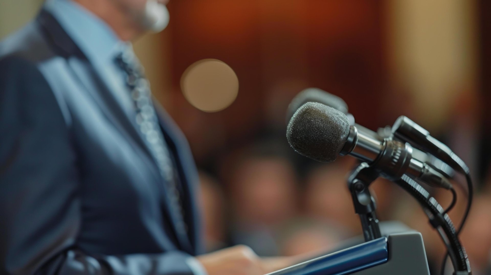 Speaker addressing an audience from a podium